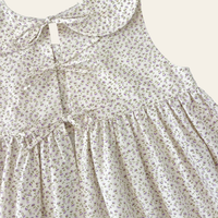 Elma Colette Dress in Haru Blossom Iris, featuring delicate purple florals on Japanese-milled cotton, a Peter Pan collar, back ties and a gathered skirt.