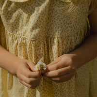 Elma Colette Dress in Japanese Floral, featuring tiny yellow flowers on a soft buttery-yellow cotton base, Peter Pan collar and gathered skirt.