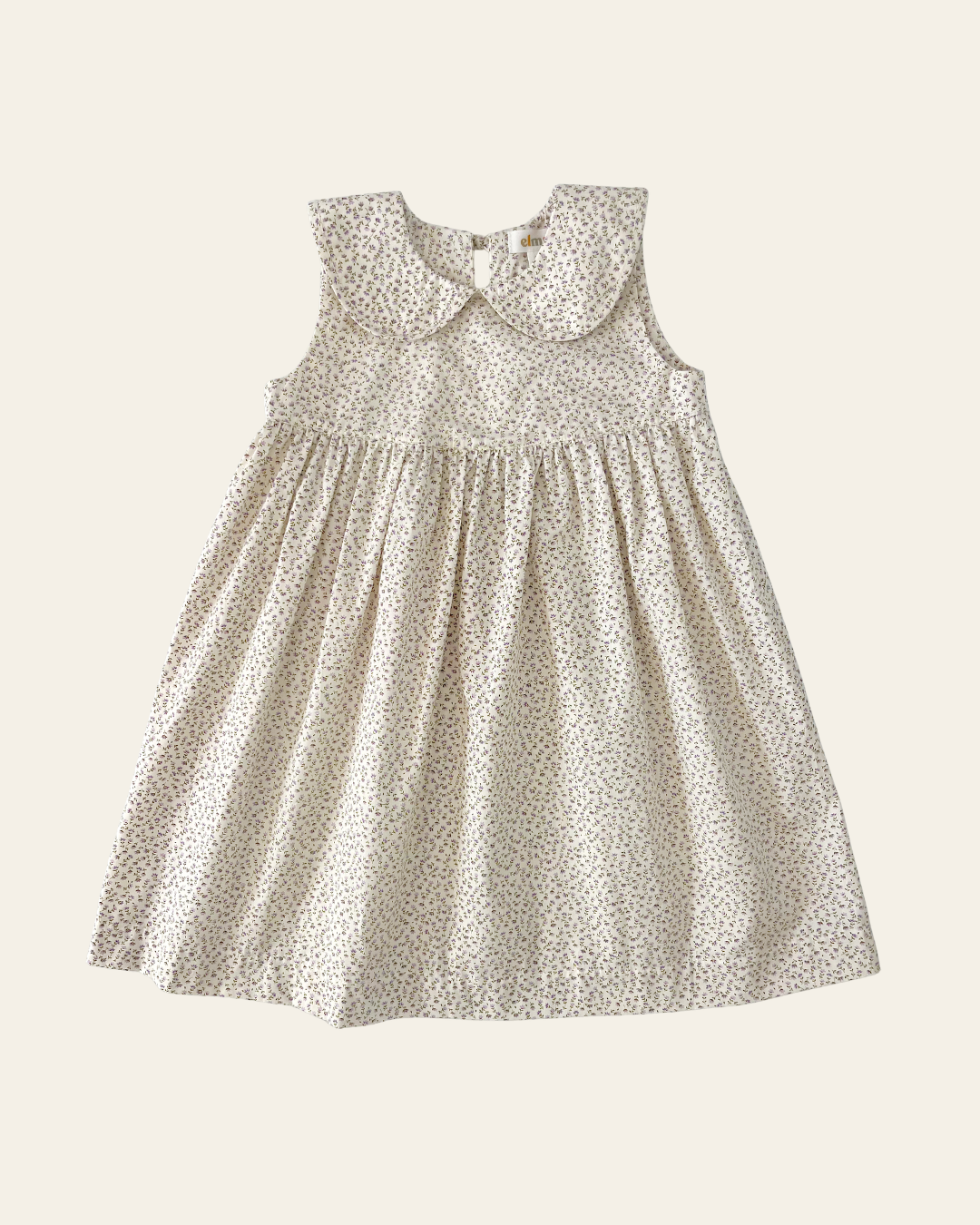 Elma Colette Dress in Haru Blossom Iris, featuring delicate purple florals on Japanese-milled cotton, a Peter Pan collar, back ties and a gathered skirt.