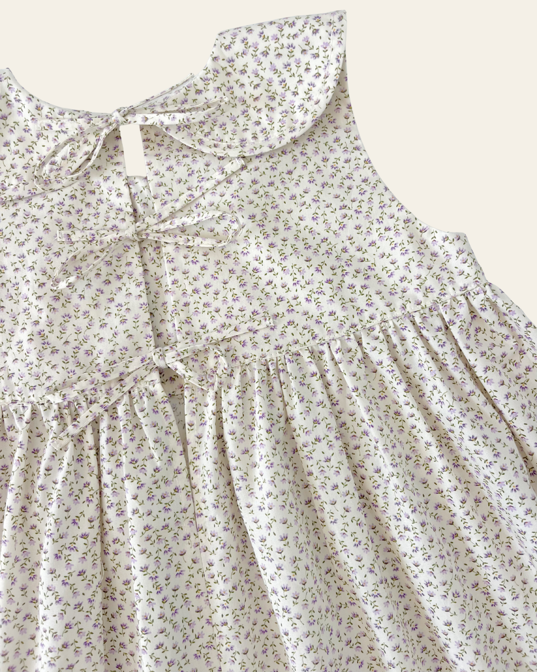 Elma Colette Dress in Haru Blossom Iris, featuring delicate purple florals on Japanese-milled cotton, a Peter Pan collar, back ties and a gathered skirt.