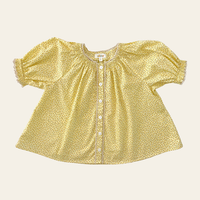 Elma Delphi Blouse in Haru Blossom Buttercup, featuring tiny yellow florals on buttery-yellow Japanese cotton, puff sleeves, shirred cuffs and picot lace trim.
