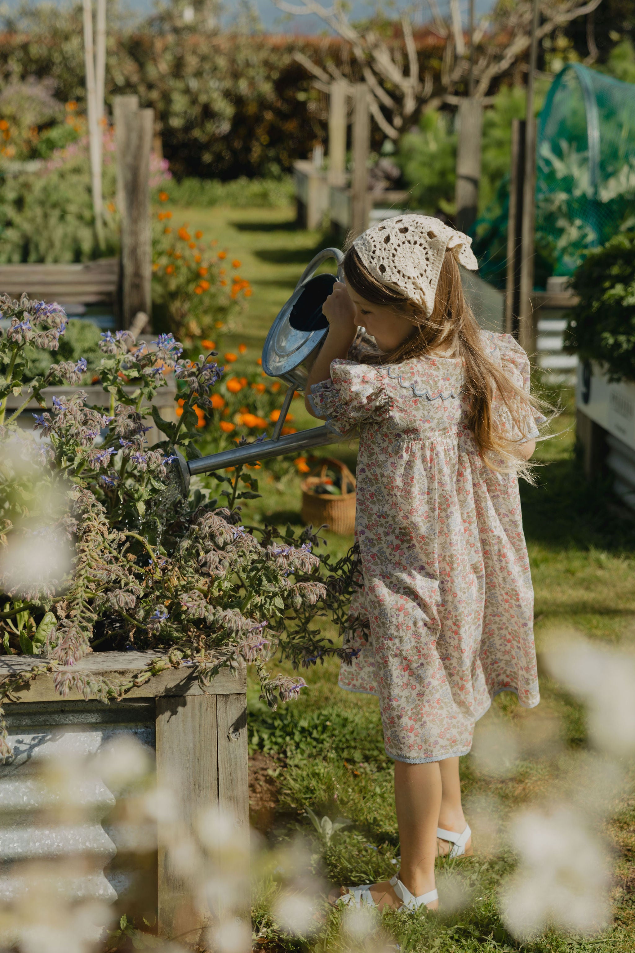 Elma Mae Dress in Liberty Nancy Ann floral cotton, featuring a scalloped collar with blue embroidery, blue buttons, puff sleeves and a gathered skirt.