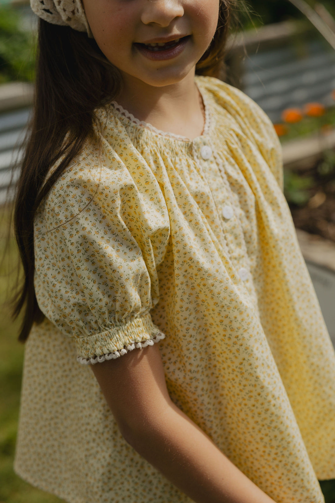 Elma Delphi Blouse in Haru Blossom Buttercup, featuring tiny yellow florals on buttery-yellow Japanese cotton, puff sleeves, shirred cuffs and picot lace trim.
