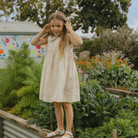 Elma Colette Dress in Haru Blossom Iris, featuring delicate purple florals on Japanese-milled cotton, a Peter Pan collar, back ties and a gathered skirt.
