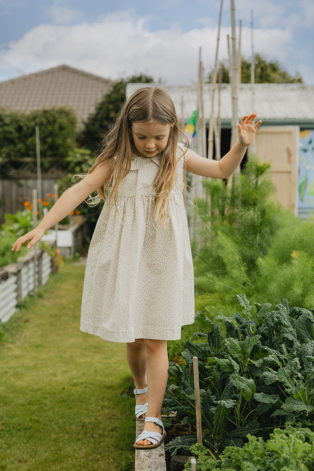 Elma Colette Dress in Haru Blossom Iris, featuring delicate purple florals on Japanese-milled cotton, a Peter Pan collar, back ties and a gathered skirt.