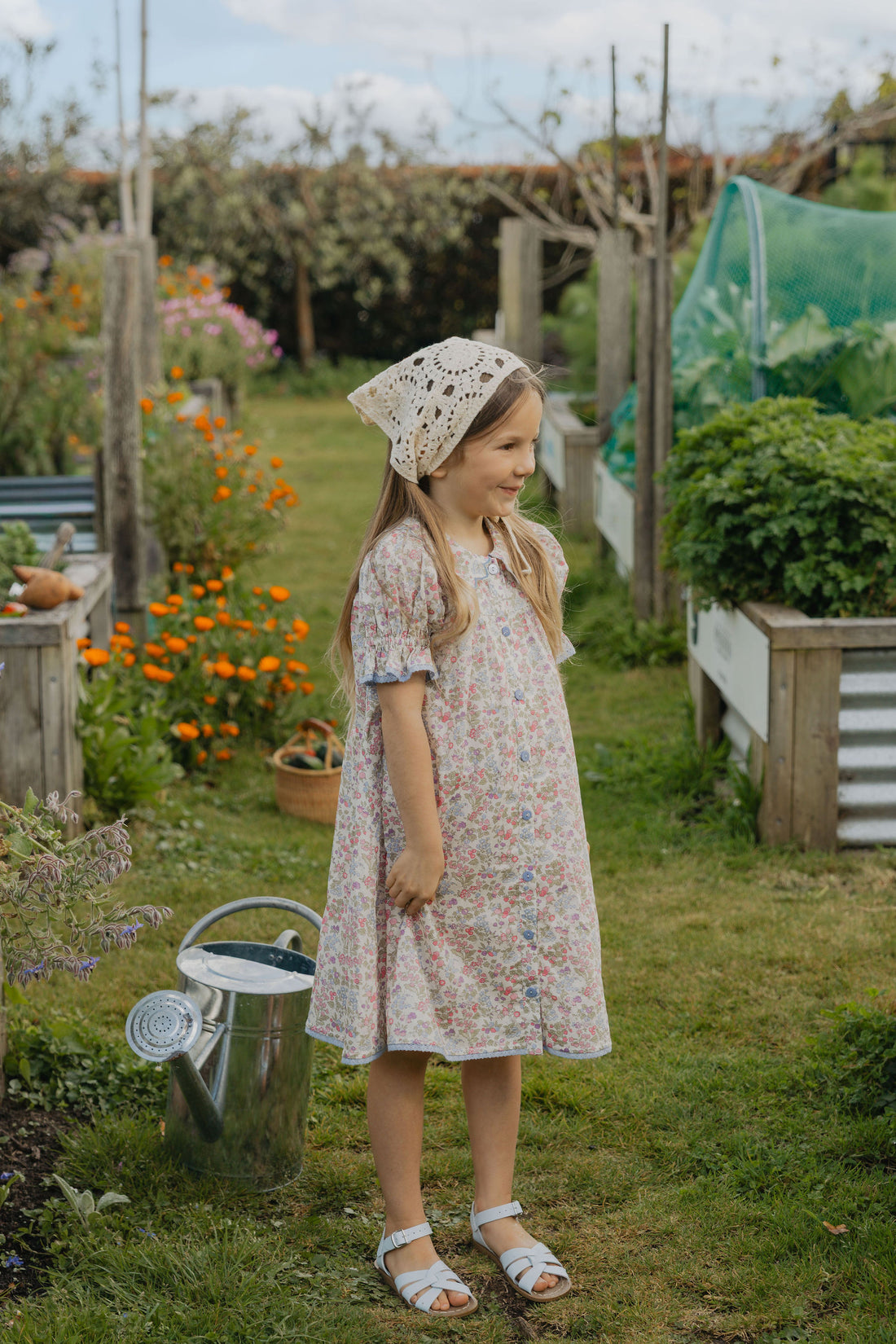 Elma Mae Dress in Liberty Nancy Ann floral cotton, featuring a scalloped collar with blue embroidery, blue buttons, puff sleeves and a gathered skirt.