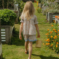 Elma Molly Shorts in Liberty Nancy Ann floral print, featuring embroidered lace trim, an elasticated self-tie waistband and side pockets.