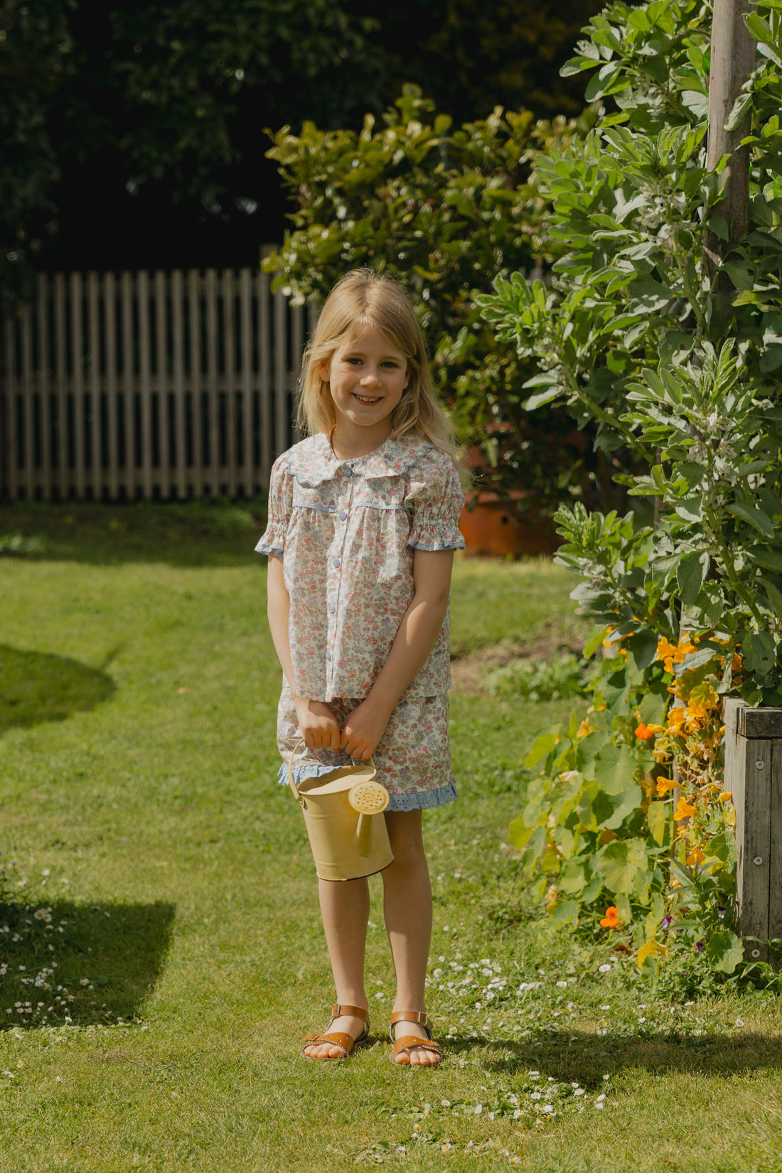 Honey Blouse in Liberty Nancy Ann floral print, featuring a scalloped Peter Pan collar, delicate lace trim, blue buttons and short puff sleeves
