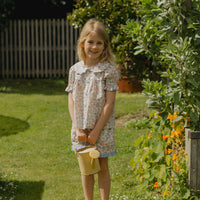 Honey Blouse in Liberty Nancy Ann floral print, featuring a scalloped Peter Pan collar, delicate lace trim, blue buttons and short puff sleeves