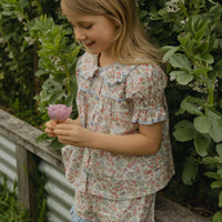 Elma Molly Shorts in Liberty Nancy Ann floral print, featuring embroidered lace trim, an elasticated self-tie waistband and side pockets.