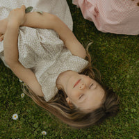 Elma Colette Dress in Haru Blossom Iris, featuring delicate purple florals on Japanese-milled cotton, a Peter Pan collar, back ties and a gathered skirt.