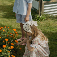 Elma Mae Dress in Liberty Nancy Ann floral cotton, featuring a scalloped collar with blue embroidery, blue buttons, puff sleeves and a gathered skirt.
