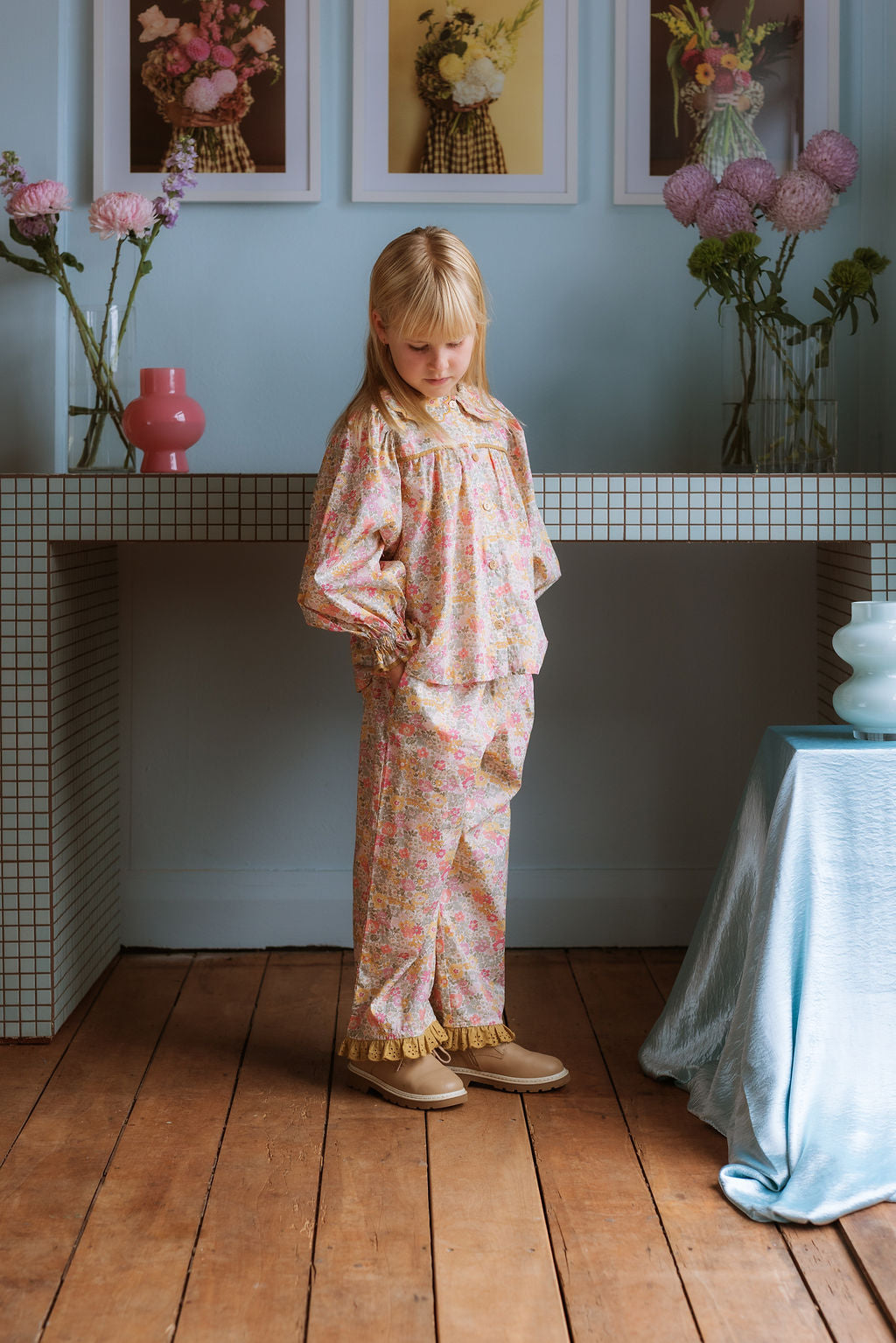 Girl wearing Lucie Pants in Liberty Morley Hill floral with embroidered lace trim and self-tie waist detail