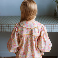 Girl wearing the Margaret Blouse in Liberty Morley Hill floral with scalloped Peter Pan collar and lace trim.