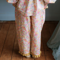 Girl wearing Lucie Pants in Liberty Morley Hill floral with embroidered lace trim and self-tie waist detail