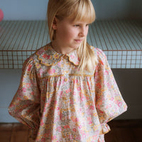 Girl wearing the Margaret Blouse in Liberty Morley Hill floral with scalloped Peter Pan collar and lace trim.