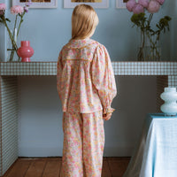 Girl wearing Lucie Pants in Liberty Morley Hill floral with embroidered lace trim and self-tie waist detail