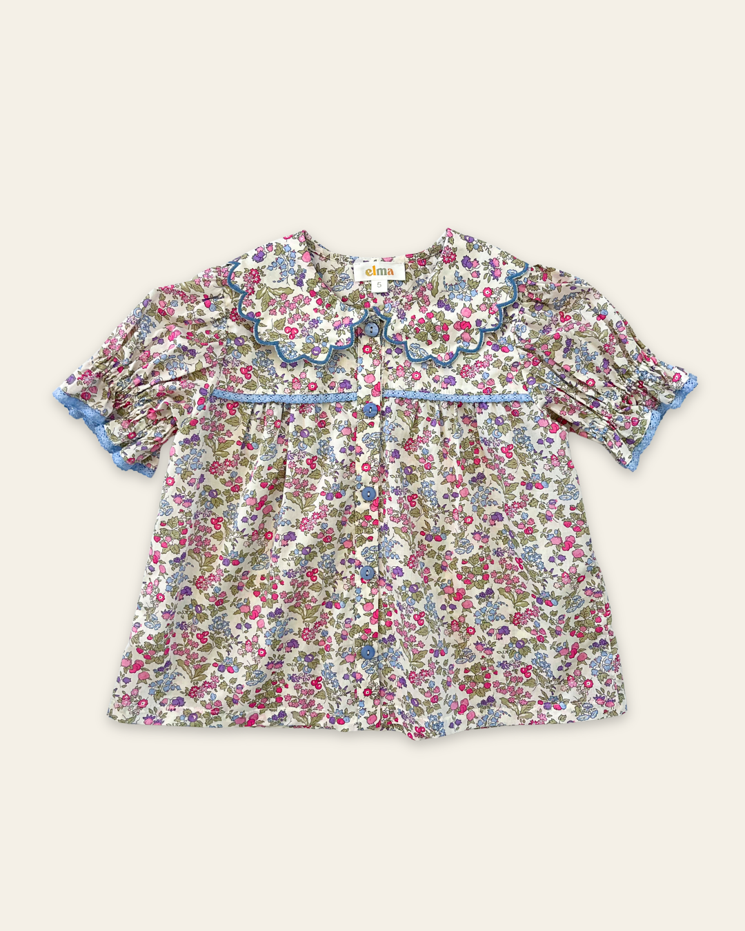 Honey Blouse in Liberty Nancy Ann floral print, featuring a scalloped Peter Pan collar, delicate lace trim, blue buttons and short puff sleeves
