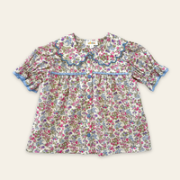 Honey Blouse in Liberty Nancy Ann floral print, featuring a scalloped Peter Pan collar, delicate lace trim, blue buttons and short puff sleeves