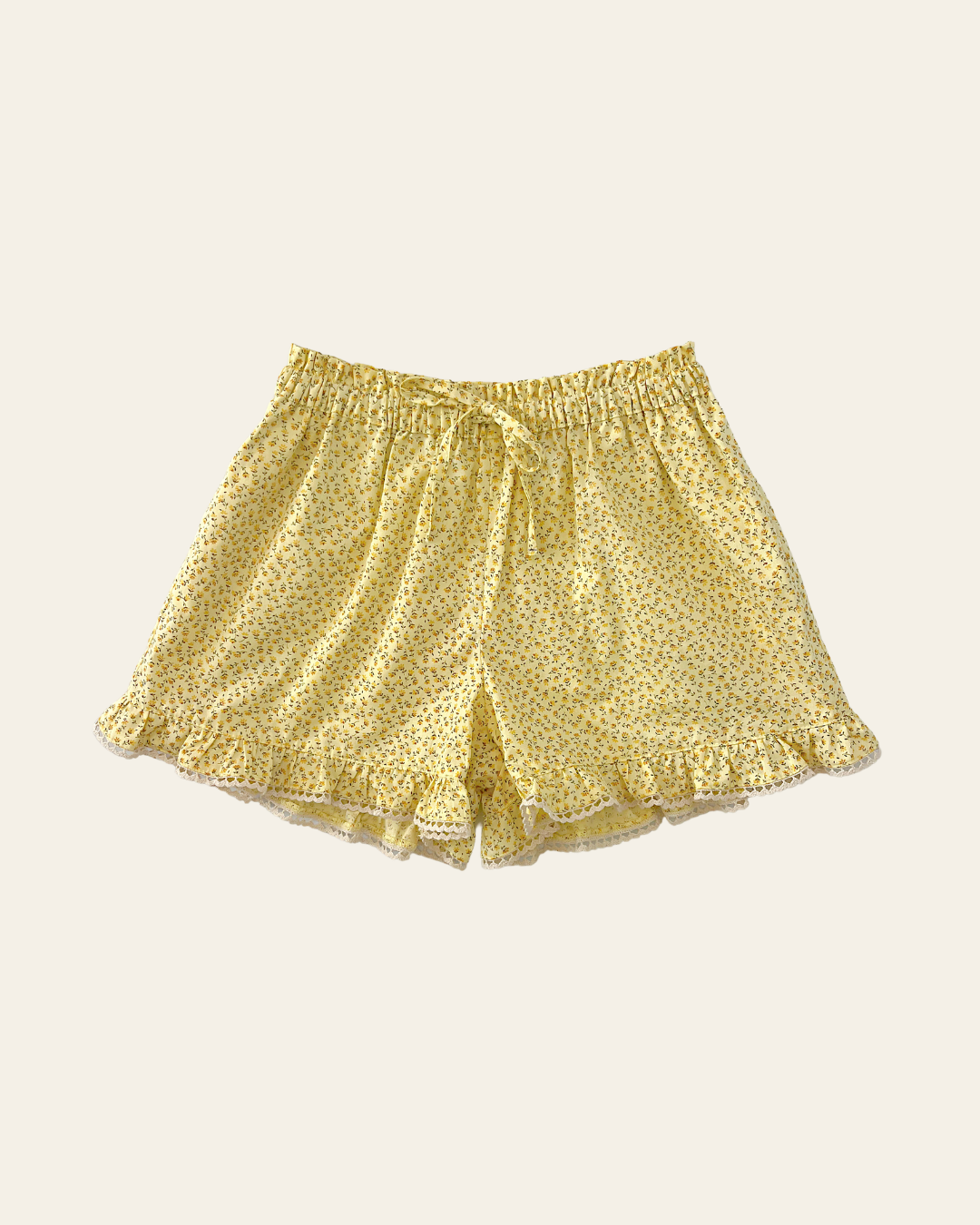 Elma Lilia Shorts in Japanese Ditsy floral, featuring an elasticated drawstring waistband, side pockets and ruffled hems with delicate white picot lace trim.