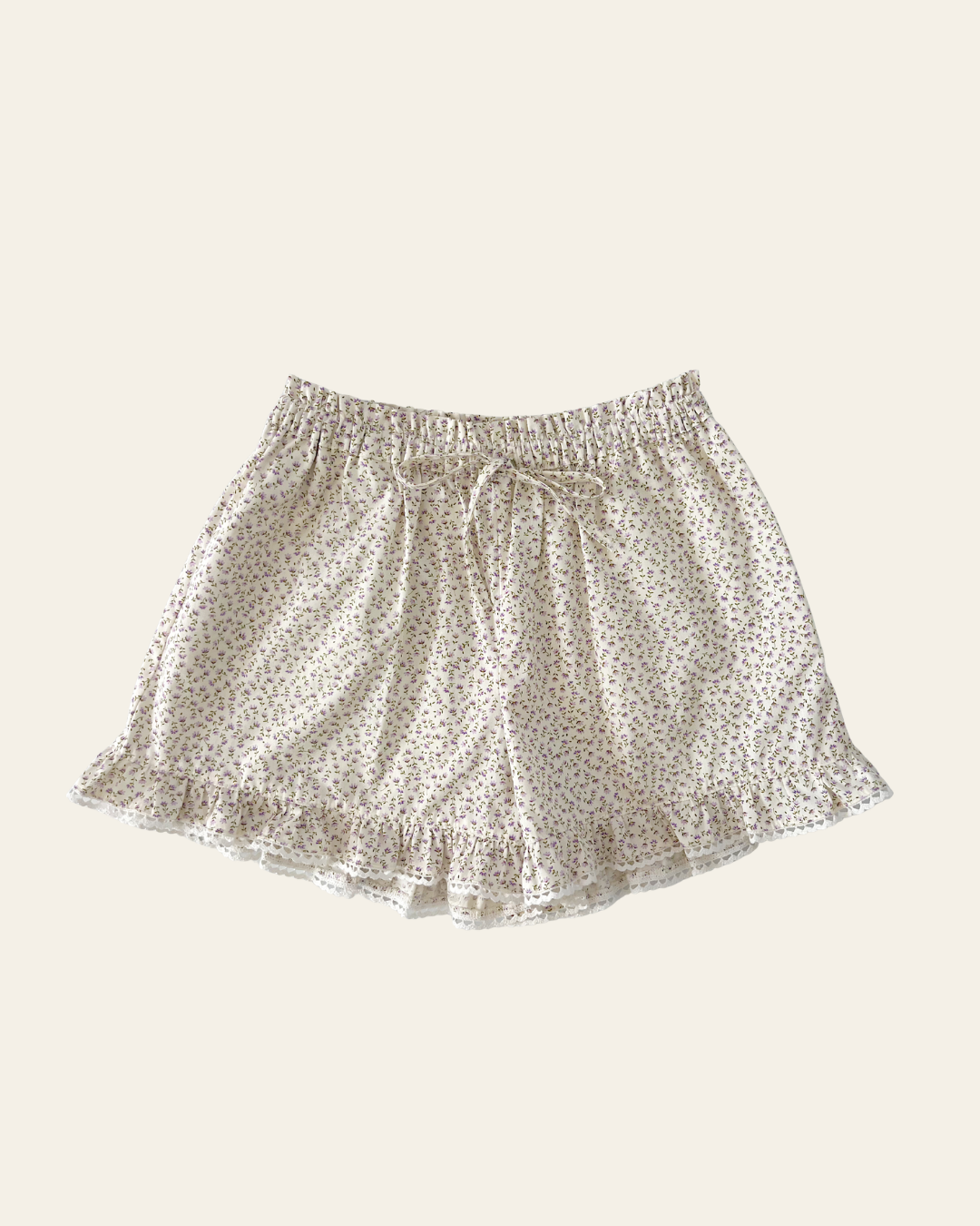 Elma Lilia Shorts in Japanese Ditsy floral, featuring an elasticated drawstring waistband, side pockets and ruffled hems with delicate white picot lace trim.